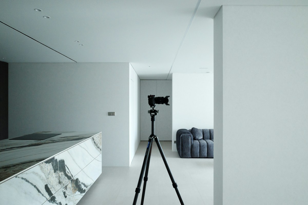 Camera on a tripod inside a modern property interior