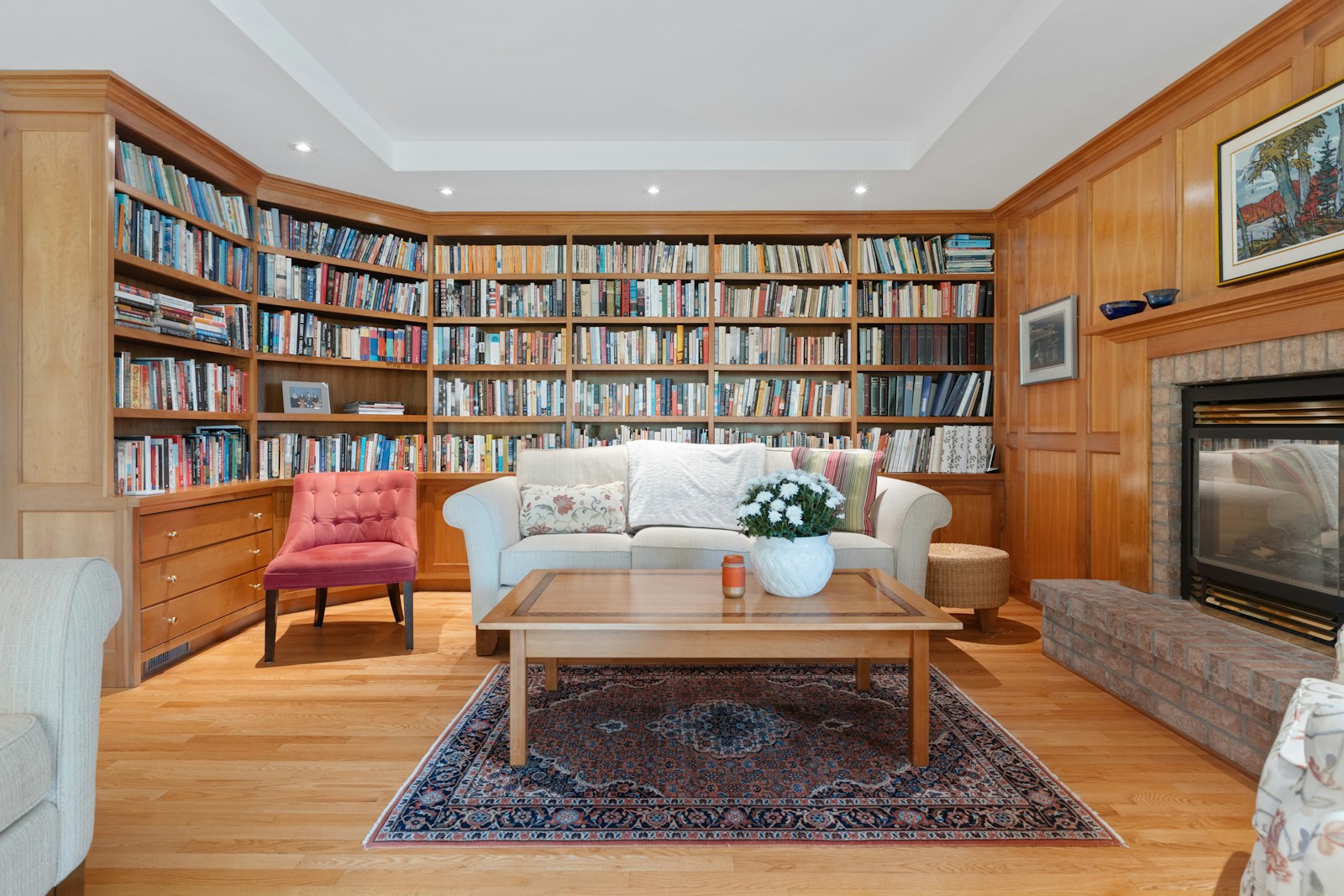 Living room with bookshelves, fireplace, and seating