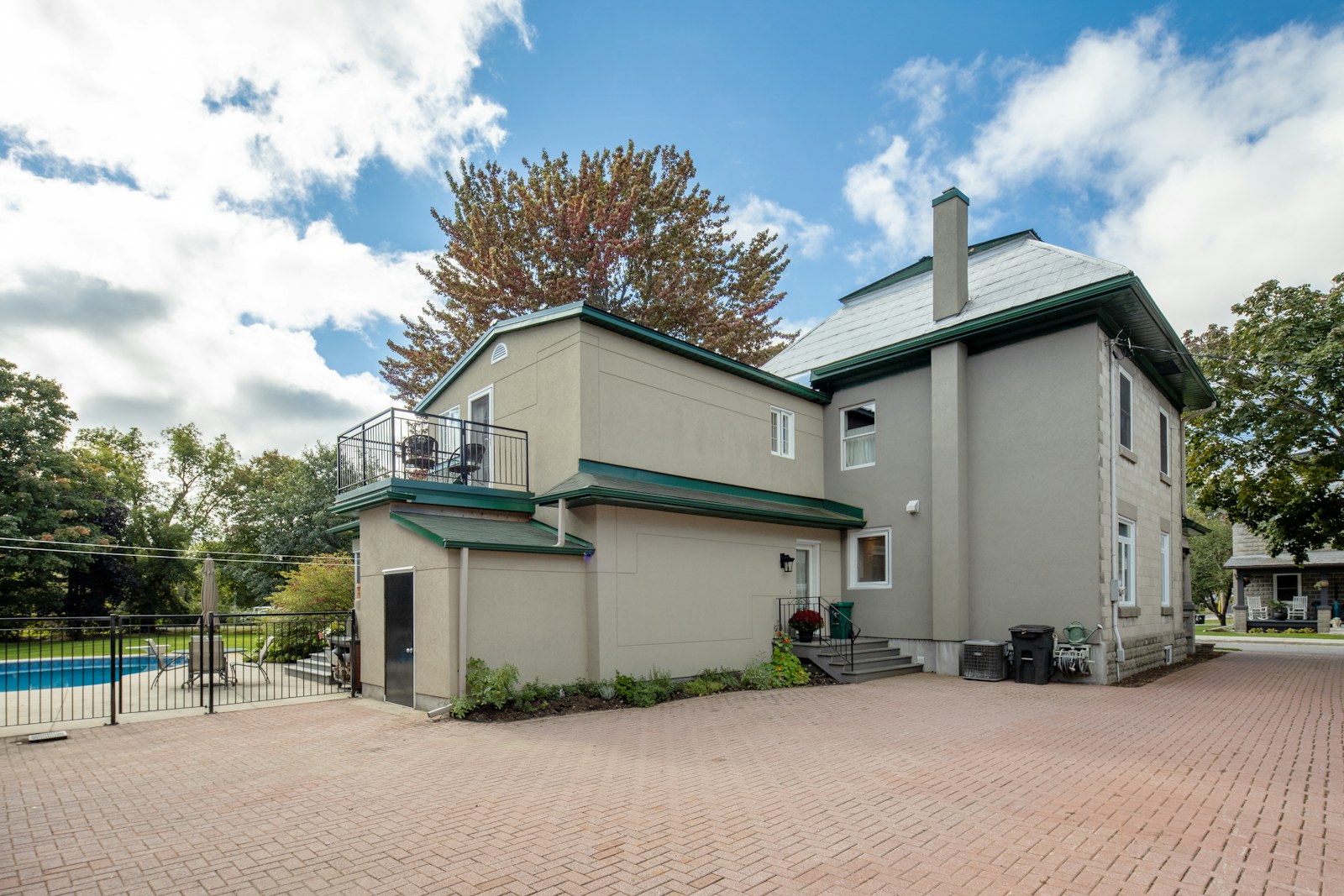 Large home with pool and paved driveway