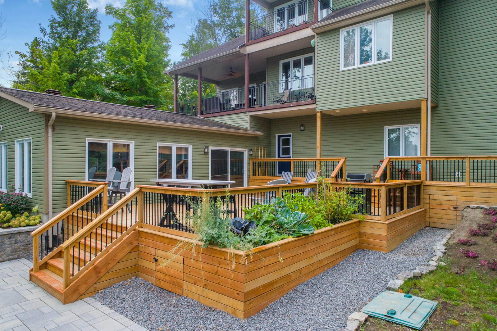 Home exterior with a wooden deck and raised planters