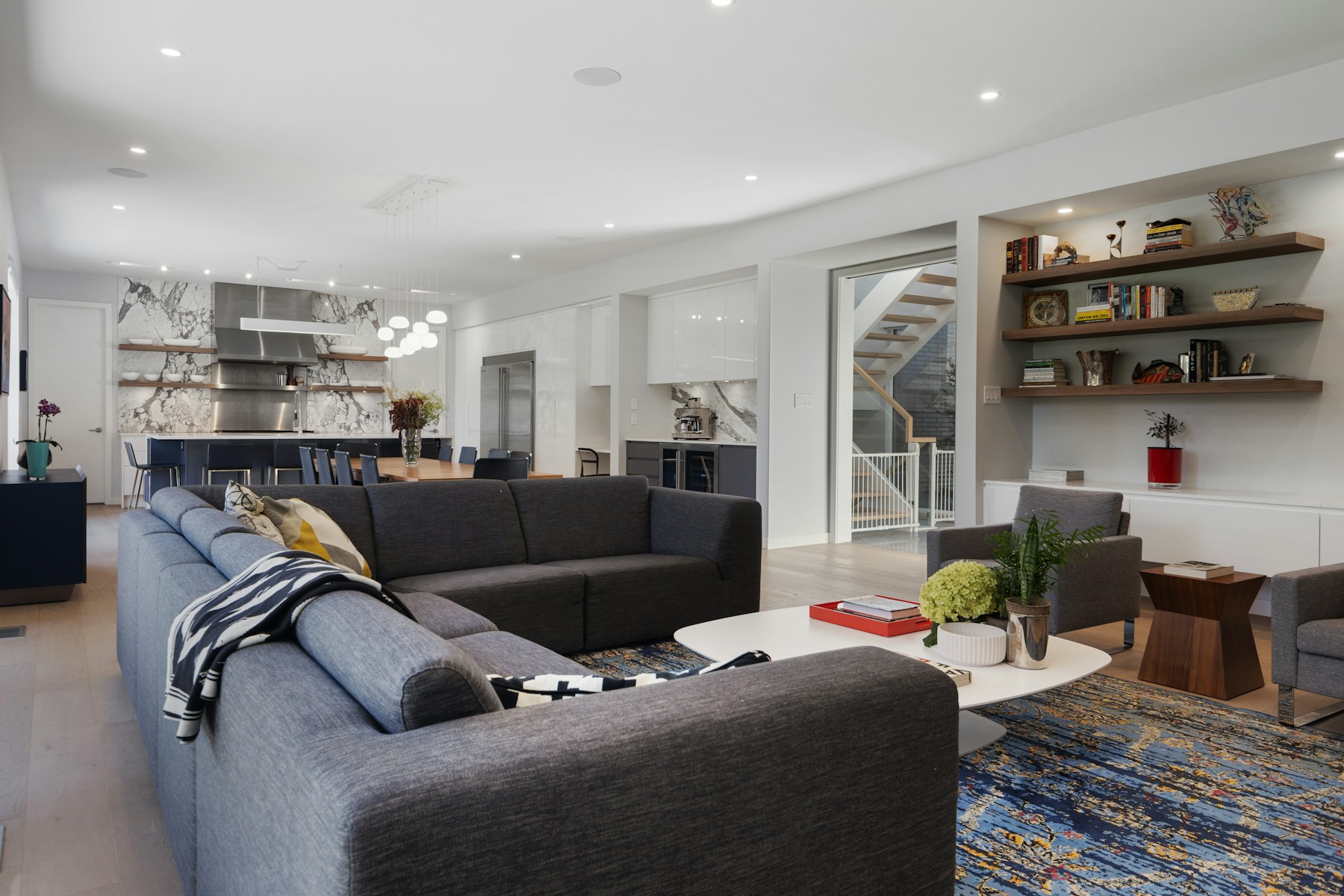 Modern living room with sectional sofas and an open kitchen