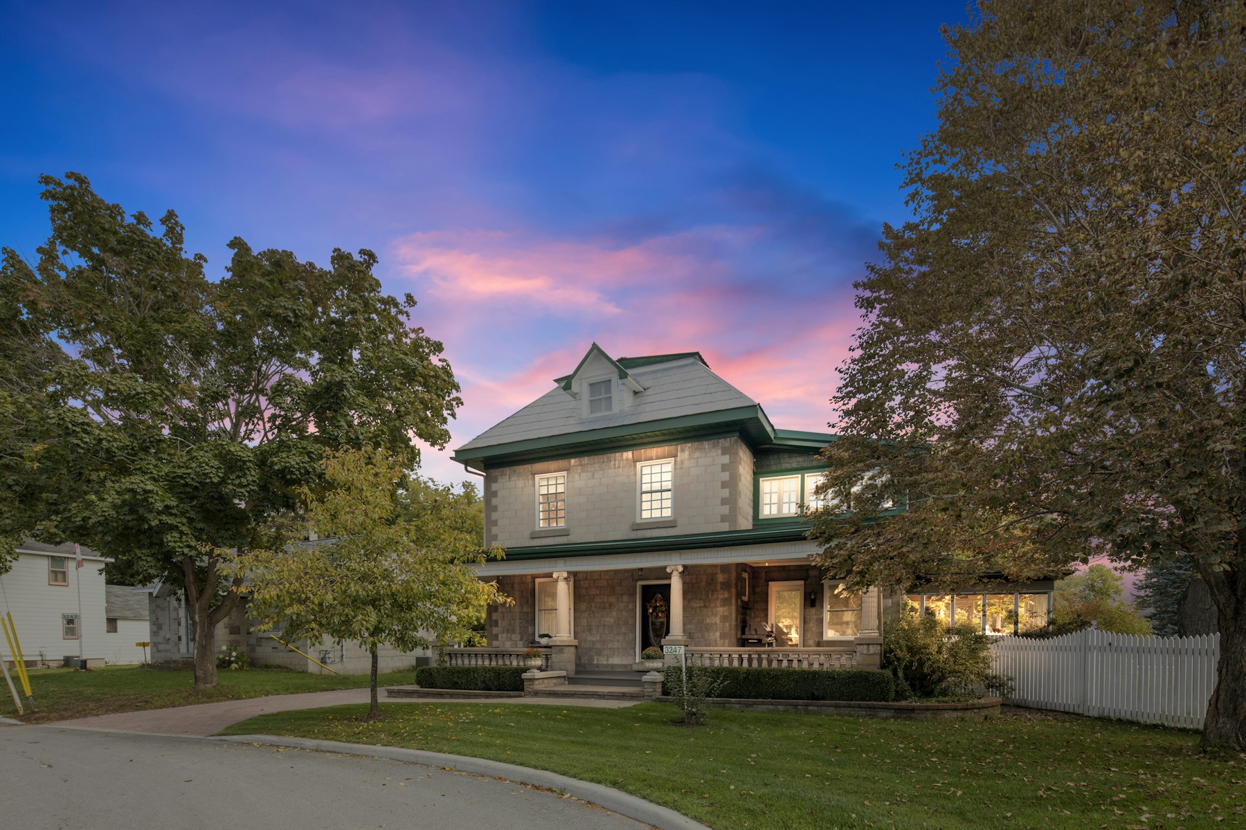 Two-story home beneath a colorful twilight sky